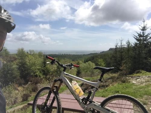 a bike parked on a bench with a view at Woodlane lodge with private Hottub & Pool table in Dumfries