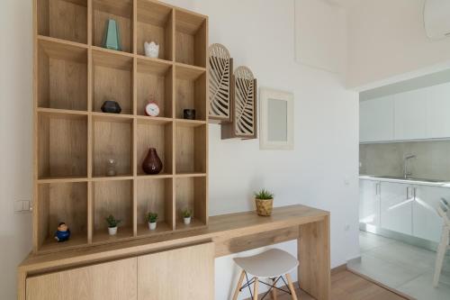 a room with a wooden shelf with vases at Parliament Sq Studio Apt in Athens