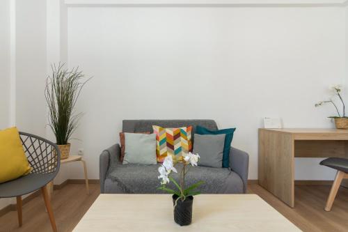a living room with a couch and a table at Parliament Sq Studio Apt in Athens
