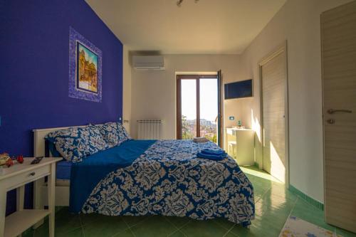 1 dormitorio con cama y pared azul en Coast2Coast, en Pianillo