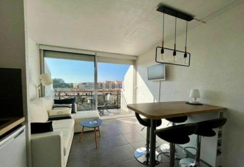 un salon avec un canapé blanc et une table dans l'établissement Double studio cabine Grau du Roi, au Grau-du-Roi