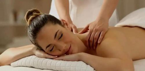 a woman getting a massage at a spa at Holiday Village Novolandia in Rapovce
