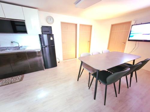 a kitchen and dining room with a table and chairs at H Stay in Incheon