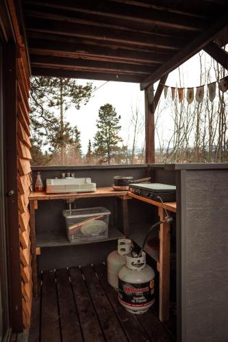 a room with a stove and a sink in a house at Yukon River Farm in Whitehorse