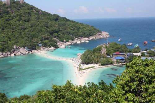an aerial view of a beach with boats in the water at Villas Sabai Jai in Koh Tao