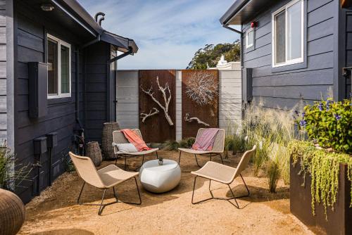 a patio with four chairs and a white vase at Fish Board Studio includes King Bed with Kitchenette and Futon in Stinson Beach