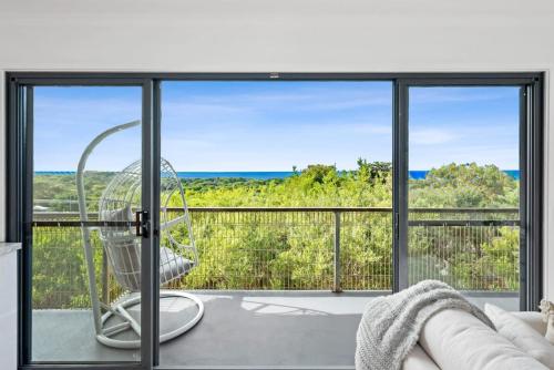 a room with a view of the ocean from a balcony at Seafarers Horizon oceanfront retreat in Ocean Grove