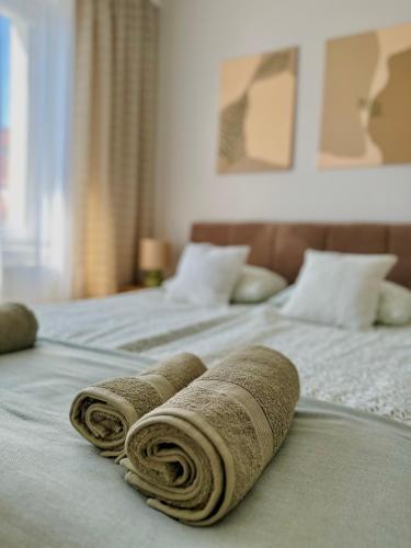 two towels are laying on top of two beds at Apartament Zielone Serce Miasta in Mrągowo