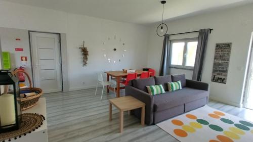 a living room with a couch and a table at Casa da Caroleira in Paços