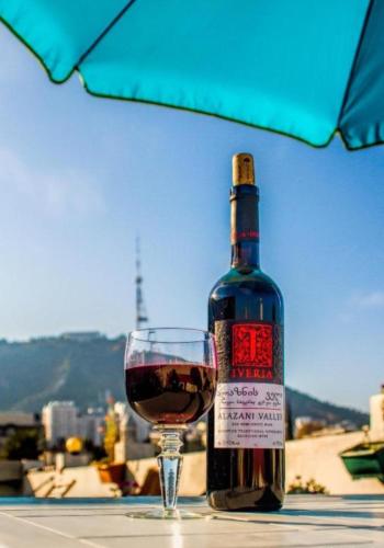 a bottle of wine sitting next to a glass at Terrace on Orbeliani in Tbilisi City