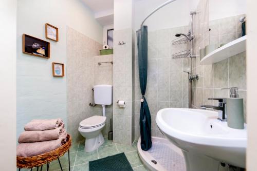a bathroom with a sink and a toilet and a shower at Vecchia Rovigno in Rovinj