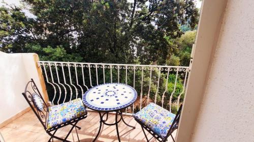 a patio with a table and chairs on a balcony at Villa Agnese in Badesi