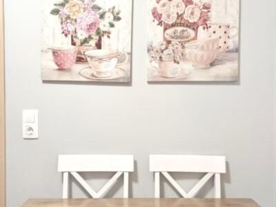 trois images sur un mur avec deux tables dans l'établissement Melenia Suites, à Rhodes
