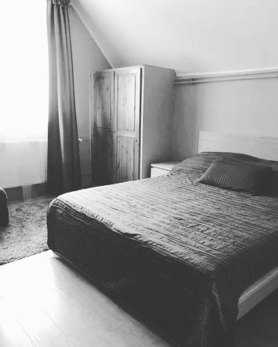 a black and white photo of a bed in a bedroom at Hullám Panorama & Jacuzzi in Balatonlelle