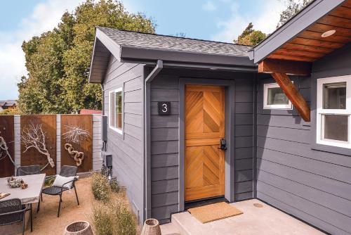 a gray house with a brown door and a patio at Funboard Room includes King Bed and Mini Kitchenette in Stinson Beach