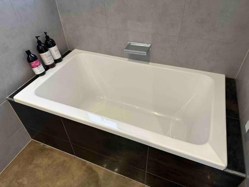 a large white bath tub in a bathroom at Mariners Retreat Unrivalled Ocean and River Views in Ocean Grove
