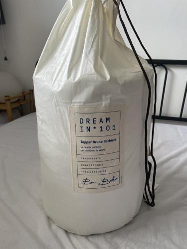 a white plastic bag sitting on top of a bed at IL Sole in Caselle Torinese