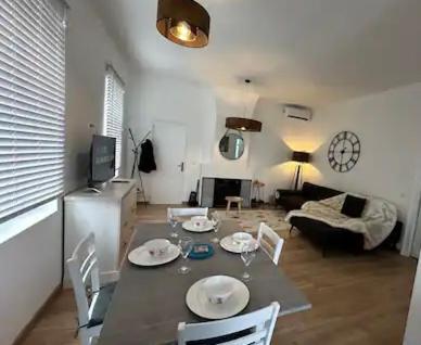 a living room with a table and a couch at 2 Route Abbeville , Labroye in Labroye