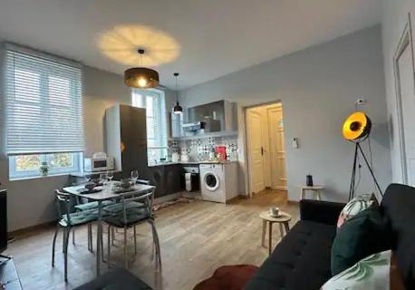 a living room with a couch and a table at 2 Route Abbeville , Labroye in Labroye