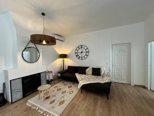 a living room with a black couch and a fireplace at 2 Route Abbeville , Labroye in Labroye