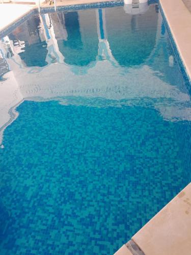an overhead view of a pool of blue water at Dar Rita in Houmt Souk