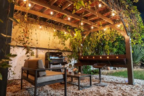 a pergola with a music table and a piano at Expansive Paradise with Private Jacuzzi and Tropical Patio in Ponce