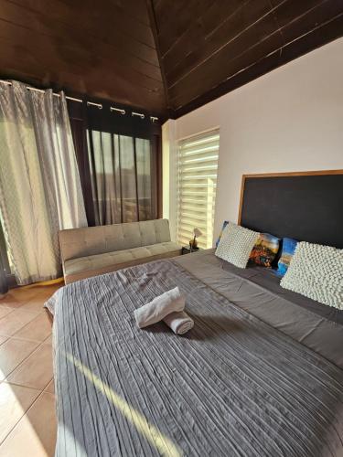 a bedroom with a large bed with a towel on it at Blue eagle Guesthouse in Santa Maria