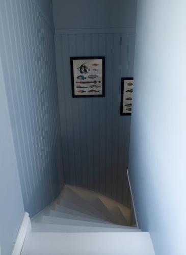 a bathroom with two pictures on the wall and a shelf at Lovely cabin with a beautiful view over Byske river in Byske