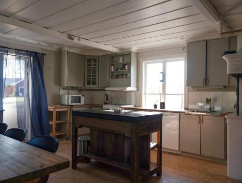 a kitchen with a wooden table in a room at Lovely cabin with a beautiful view over Byske river in Byske
