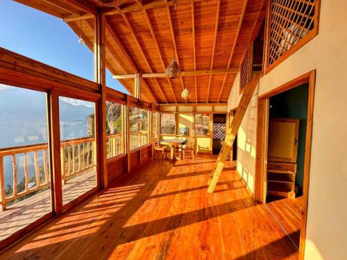a large wooden balcony with a table and chairs at The Chalet - 4 bedrooms - stunning lake view in San Marcos La Laguna