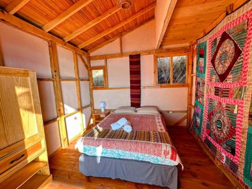 a bedroom with a bed in a wooden cabin at The Chalet - 4 bedrooms - stunning lake view in San Marcos La Laguna