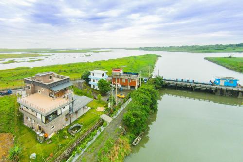 an aerial view of a house next to a river at Lanyang Beach Villa in Wujie