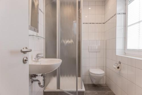 La salle de bains est pourvue d'une douche, d'un lavabo et de toilettes. dans l'établissement 50034..., à Carolinensiel