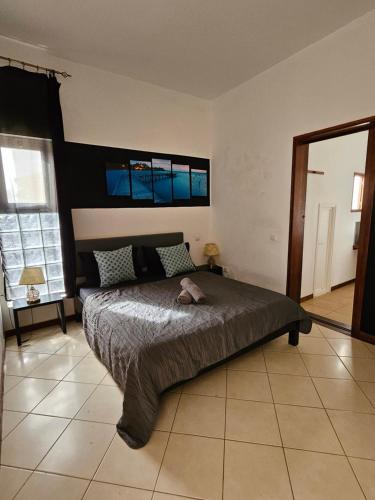 a bedroom with a bed and a large window at Blue Eagle Guesthouse - Casa de hospedes in Santa Maria