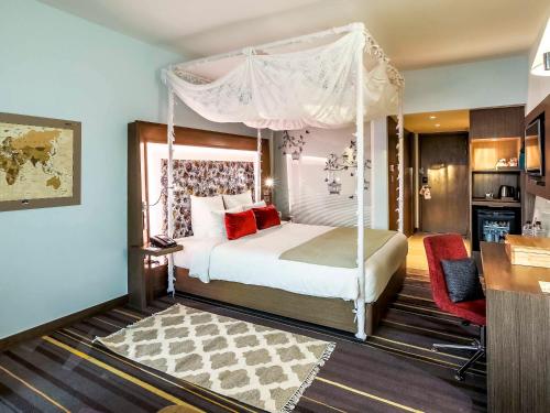a bedroom with a bed with a canopy at Novotel New Delhi Aerocity- International Airport in New Delhi