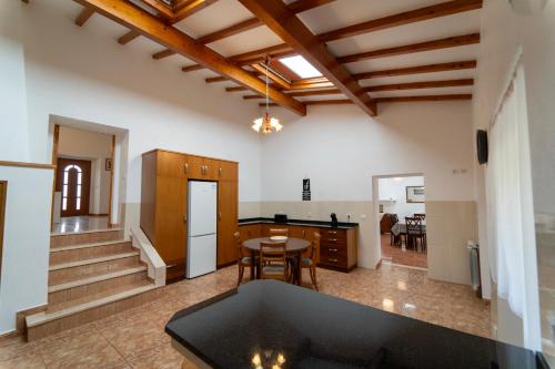 a kitchen and living room with a table and chairs at Casa Torre das Andorinhas in Nazaré