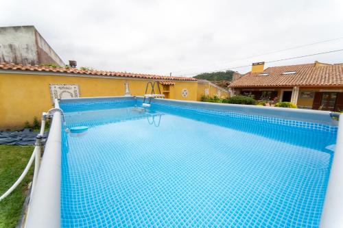 a large blue swimming pool in a house at Casa Torre das Andorinhas in Nazaré