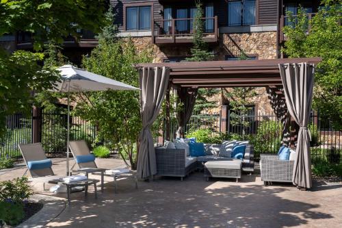a gazebo with chairs and tables and an umbrella at Waldorf Astoria Park City in Park City