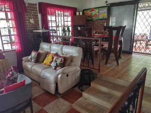 a living room with a couch and a table at Villa Kyra in Calima
