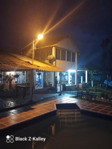 a house with a swimming pool at night at Villa Kyra in Calima