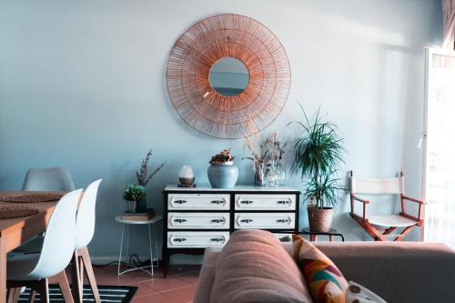a living room with a couch and a mirror at CABEDELO BEACH FLAT in Viana do Castelo