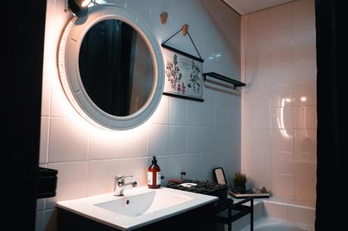 a bathroom with a sink and a mirror at CABEDELO BEACH FLAT in Viana do Castelo