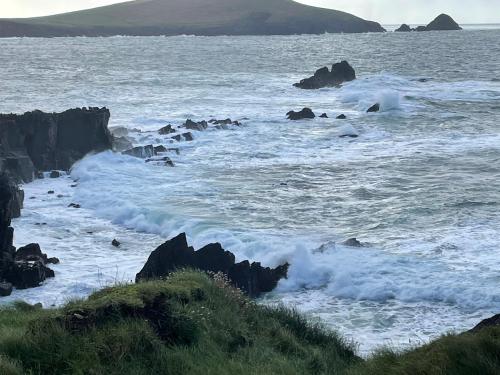 a view of the ocean with rocks and waves at Murphy's Guesthouse in Dingle