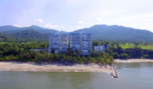 an aerial view of a building on a beach next to the water at Los Alcatraces in Santa Marta