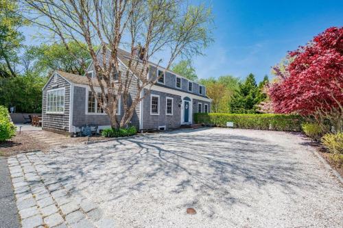a house with a driveway in front of it at 14 Hallet Lane Chatham Cape Cod - - Sand Simeon in Chatham