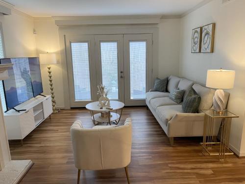 a living room with a couch and a table at The Garden Room at Galleria in Houston