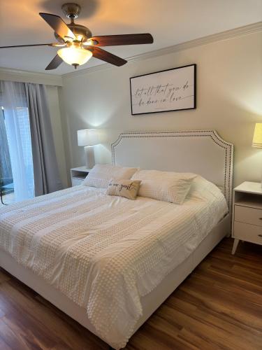 a bedroom with a bed with a ceiling fan at The Garden Room at Galleria in Houston