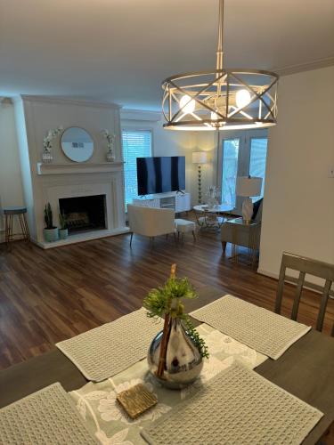 a living room with a fireplace and a dining room at The Garden Room at Galleria in Houston