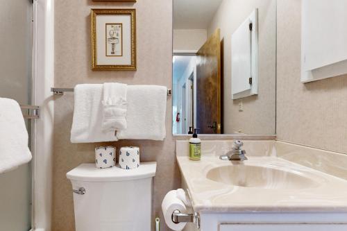 a bathroom with a sink and a toilet with towels at Katherine Court Townhouse in Stateline