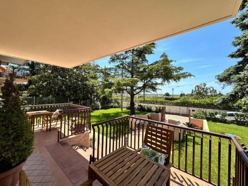 a balcony with a bench and a view of a park at Dimora Don Antonio in Pontecagnano